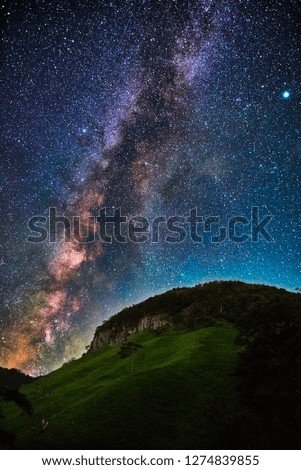 Milky way and the large rocky hill in summer 