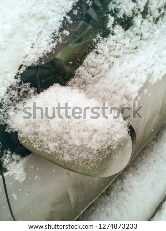 Snow on a car in winter .