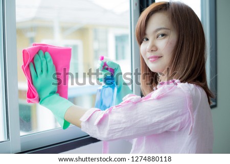 Cleaning concept. Asian woman washing window