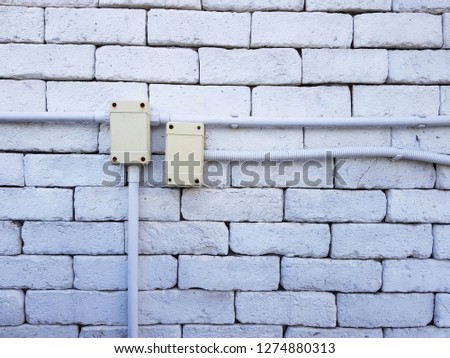 Electrical outlet on a red brick wall concept of power or connectivity,Power outlets on the brick wall vertical orientation.
