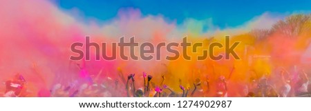 Crowd throwing bright coloured powder paint in the air, Holi Festival Dahan Royalty-Free Stock Photo #1274902987