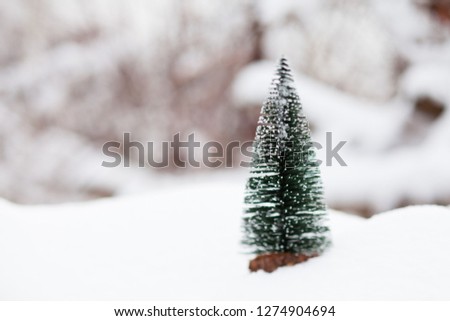 Little toy spruce on the snow, Christmas concept
