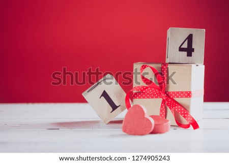Concept photography of Valentine's gift with wooden calendar shows the date 14 february.  