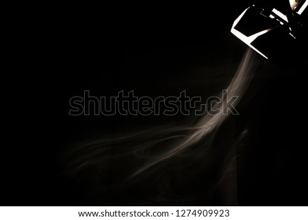 
Movie illuminator illuminating white smoke. On a black background.