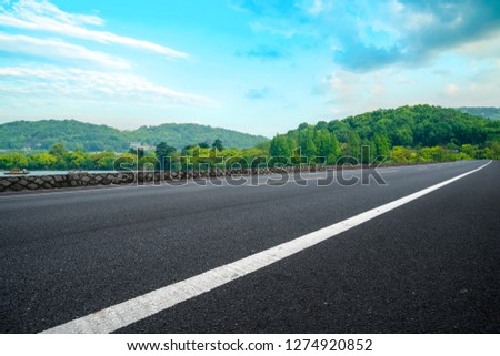 Empty asphalt road and natural landscape under the blue sky
