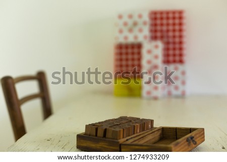 Close up of opened small stamp box  on wooden table and chair wi