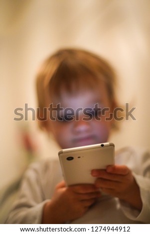 Little baby girl with smartphone in her hands. 
