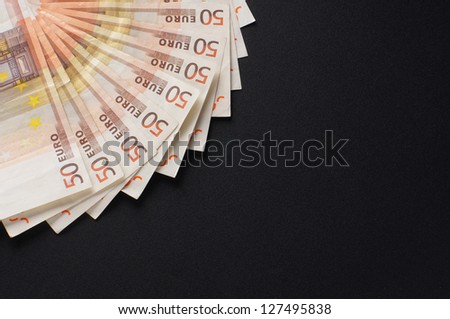 A lot of european money over black background
