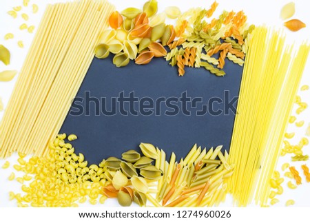 Frame of raw wheat pasta. Place for text (recipe). Food background.  