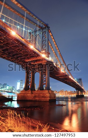 New York City Manhattan Bridge closeup with downtown skyline over East River.
