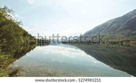 Beautiful photo of lake lake Bohinj in Slovenia, reflecting the Alp mountains