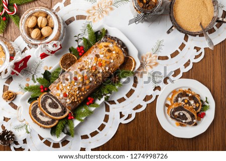 Poppy seed roulade in Christmas decoration. Served with coffee or tea. Top view.