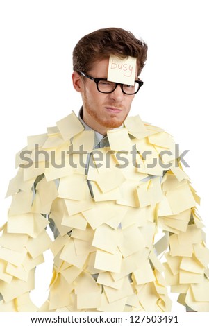 Young male with a sticky note on his face, covered with yellow sticky notes, isolated on white