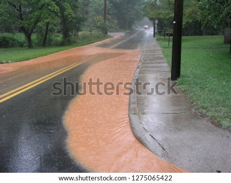 Storm water runoff on road after heavy rain in North Carolina  Royalty-Free Stock Photo #1275065422