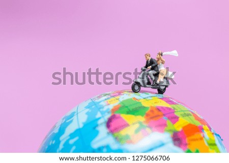 Miniature people : Couple riding the motorcycle on The Globe , Valentines concept