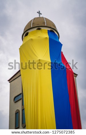 Big Colombian flag over a church