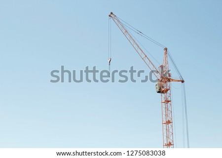 Constructions cranes near building. Picture of Construction site with crane and building.