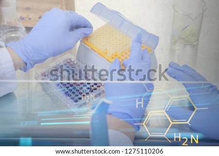 Two young female Laboratory scientists working at lab with test tubes and microscope, test or research in clinical laboratory.Science, chemistry, biology, medicine and people concept.