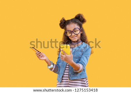 Banking card. Happy positive girl holding a debit card while making a payment Royalty-Free Stock Photo #1275153418