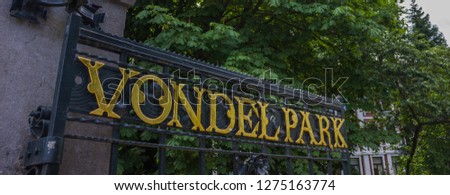 A picture of a metal gate that marks the entrance to Vondelpark (Amsterdam).