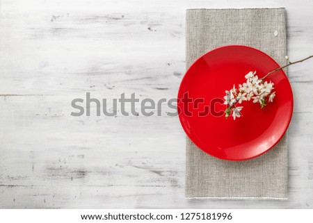 Spring table set with plates and blooming white flowers branch. top view with copy space