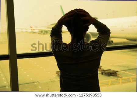  Woman silhouette upset, sad, crazy or insane when seeing airplane                              