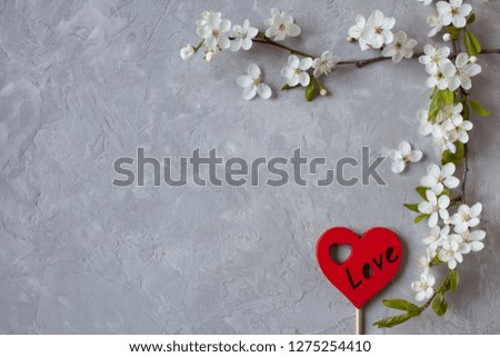 Background with blooming spring branches and red heart for congratulations