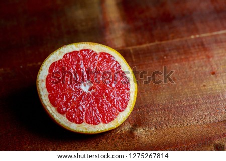 Close up Freshly harvested grapefruit on wooden background board, dark black background, macro picture. copy spave