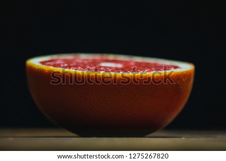 Close up Freshly harvested grapefruit on wooden background board, dark black background, macro picture. copy spave