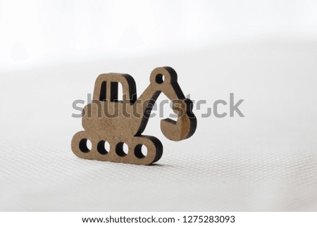 Decoration in the form of an excavator, educational toy on a white background