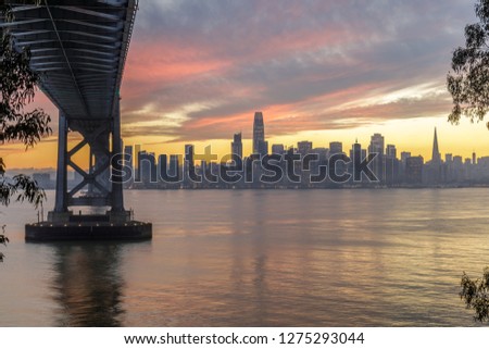 Under The Bridge. Winter Sunset over the Bay Bridge and San Francisco Skyline. Yerba Buena Island, California, USA.