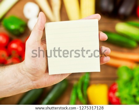 Holding a blank groceries list