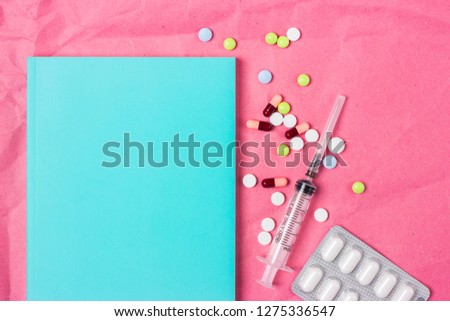 Blank space frame for text on a cover note book or diary. Medical background with color pills, pills and capsules for a slide or presentation. Top view