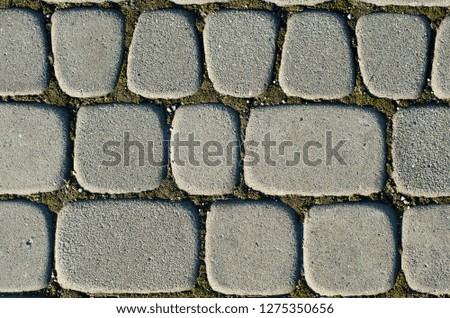 Asymmetric paving slabs of gray color, different size. Background