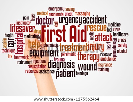 First aid word cloud and hand with marker concept on white background.