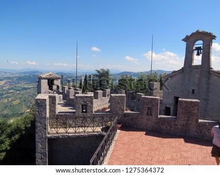 Tower of La Cesta, church with a bell and a 
beautiful landscape, Republic of San Marino, Italy.
                      