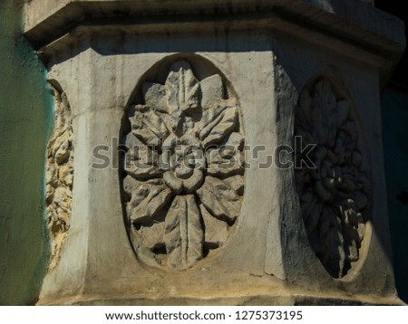 Antique decor with flower ornament. Floral decor on wall. Pseudo-gothic architecture. Motley ornament on house. Building construction. Russian classic architecture. Sightseeing in Moscow.