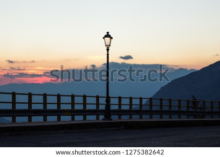 evening sunset outdoor highland street scenic atmosphere view with lantern on mountains and sky background 