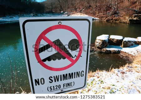 A no swimming sign with a warning of an $120 fine in Apple River Canyon State Park Illinois