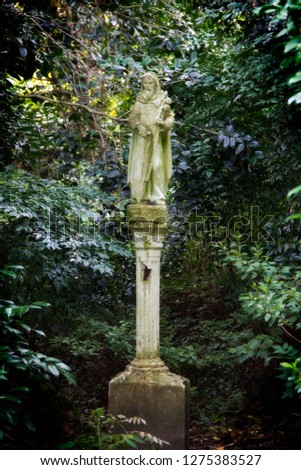 statue in the middle of a green garden at Magnolia plantation in Charleston South Carolina