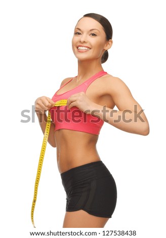 picture of sporty woman measuring her breast