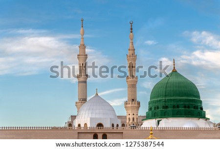 Exterior view of minarets and green dome of a mosque taken off the compound. Royalty-Free Stock Photo #1275387544
