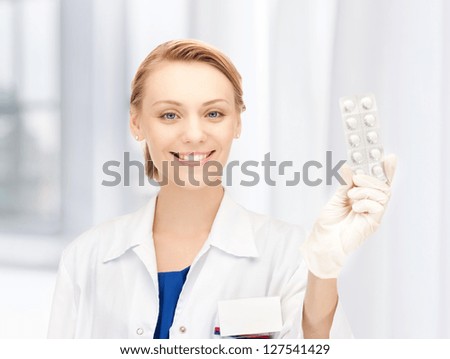 picture of attractive female doctor with pills