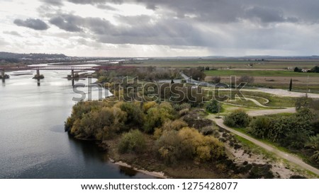 Landscape of Chamusca Bridge with a tagus river and a cloudy sky. Chamusca Town, Portugal