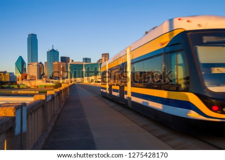 Moving streetcar on the Houston Street Viaduct with the city of Dallas in background. 