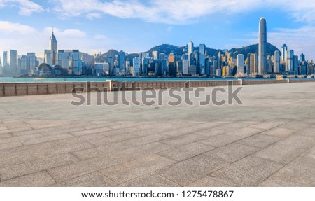 Empty marble floors and city views under the blue sky