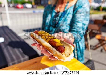 Ordering a hot dog at the market. Close up picture shot outside on a sunny day in a french farmer's market of Quebec, Canada.