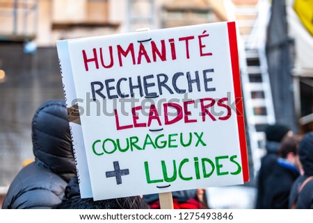 Activists marching for the environment. French sign seen in an ecological protest saying humanity is looking for courageous and lucid leaders
