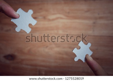 Closeup hand of woman connecting jigsaw puzzle with sunlight effect, Business solutions, success and strategy concept - Image