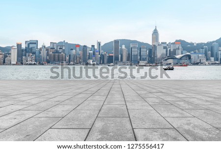 Empty marble floors and city views under the blue sky